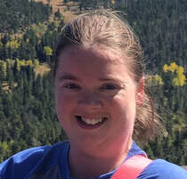 Photo of Carrie Stiernagle a young, white women with dark blond hair. Her hair is in a ponytail and she is wearing a blue tshirt, she is outside